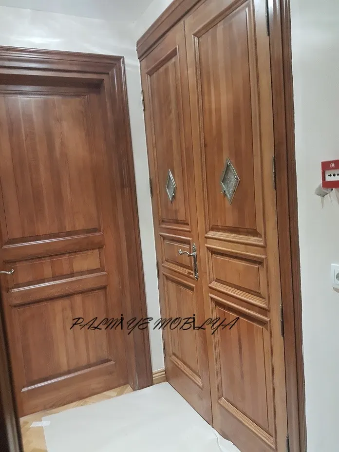 Elmas cam süslemeli çift kanatlı ahşap kapı ile yanındaki tek kanatlı panelli kapı